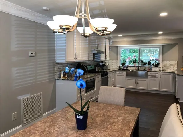 a kitchen with a stove top oven and refrigerator