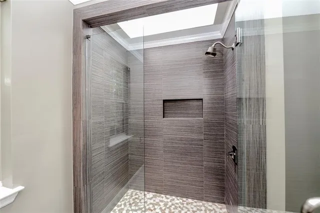 a spacious bathroom with a double vanity sink a large mirror and a toilet