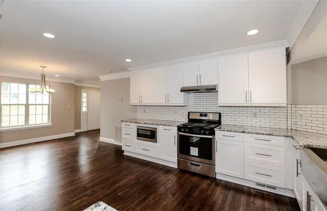 a kitchen with wooden floors and appliances
