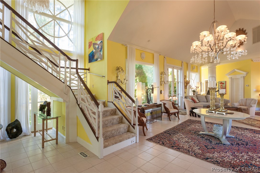 119 Falling Tide Road Deltaville, VA 23043 - Photo 12 of 44 Another view of the foyer and stairway framed by a wall of windows