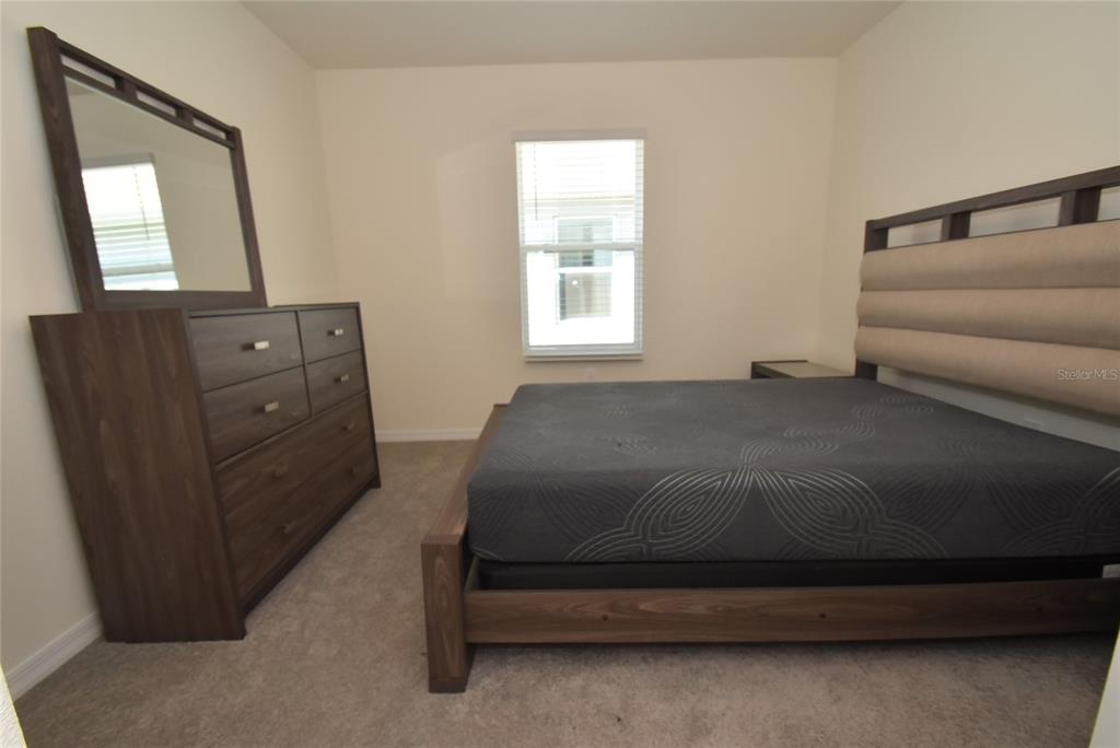 17918 Canopy Place Bradenton, FL 34211 - Photo 12 of 15 a bedroom with a bed and a mirror