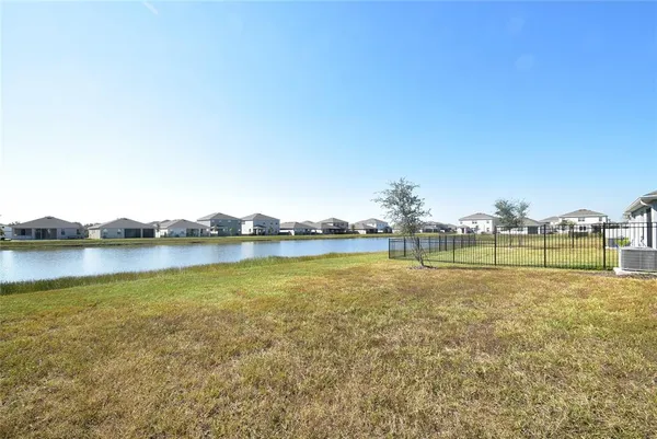 a view of a lake with houses in the back