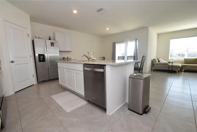 a kitchen with refrigerator and cabinets