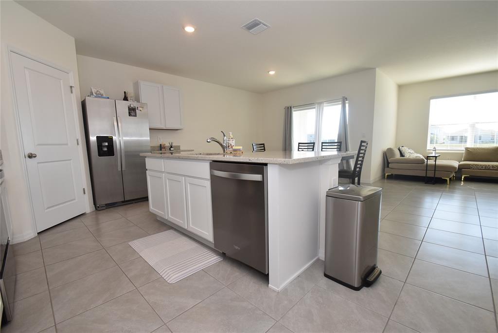 17918 Canopy Place Bradenton, FL 34211 - Photo 2 of 15 a kitchen with refrigerator and cabinets
