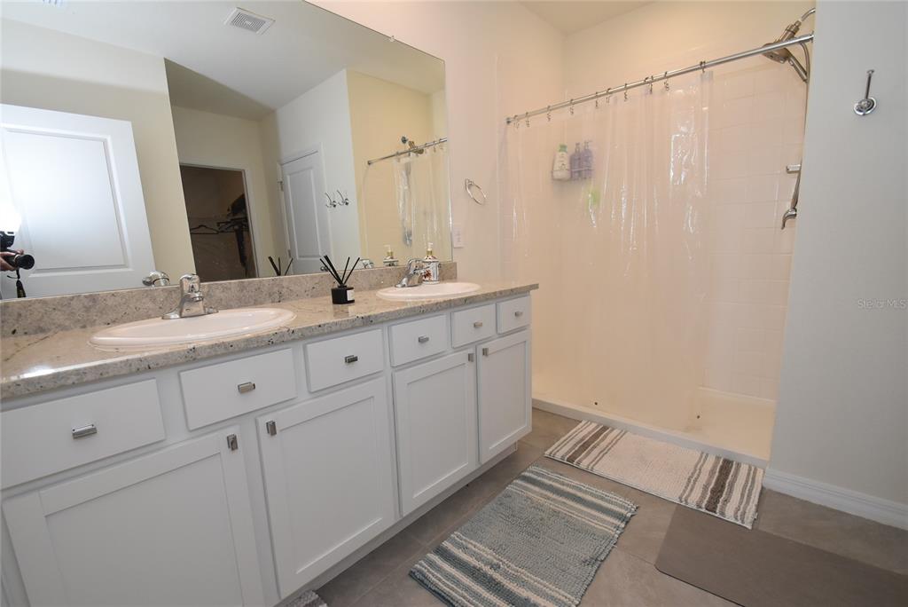 17918 Canopy Place Bradenton, FL 34211 - Photo 8 of 15 a bathroom with a double vanity sink and mirror