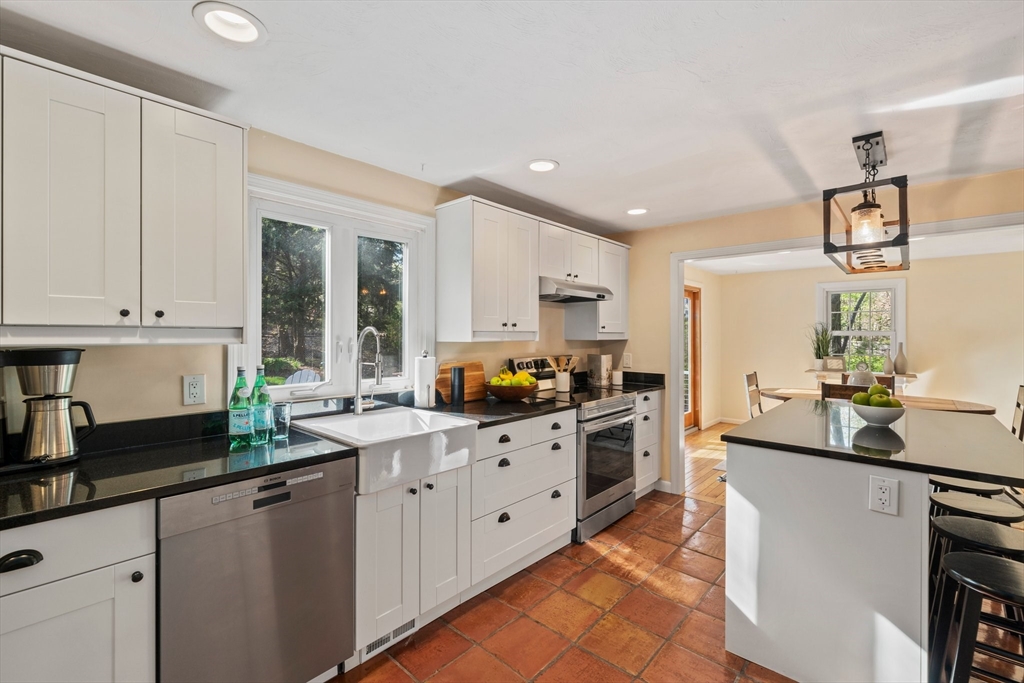 1563 Bay Road Sharon, MA 02067 - Photo 11 of 41 a kitchen with granite countertop a sink stove and cabinets