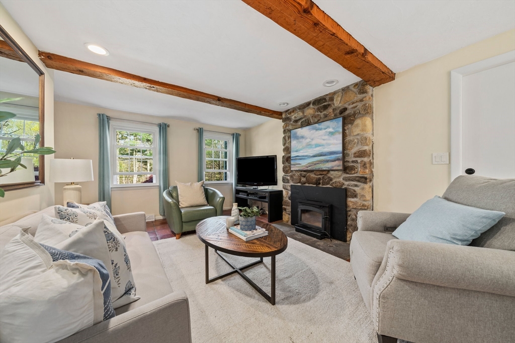 1563 Bay Road Sharon, MA 02067 - Photo 13 of 41 a living room with furniture fireplace and a flat screen tv