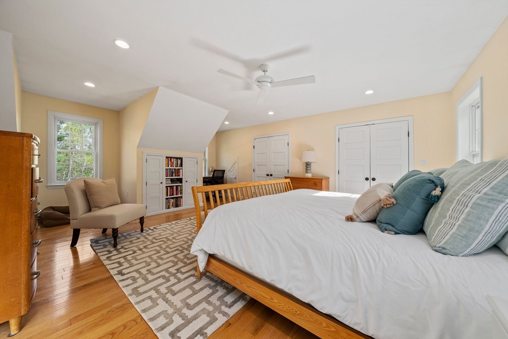 1563 Bay Road Sharon, MA 02067 - Photo 18 of 41 a large bedroom with a bed and wooden floor