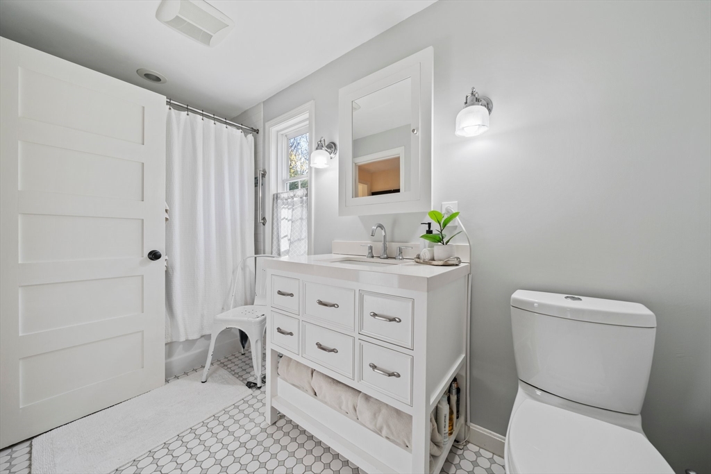 1563 Bay Road Sharon, MA 02067 - Photo 22 of 41 a bathroom with a granite countertop toilet sink and mirror