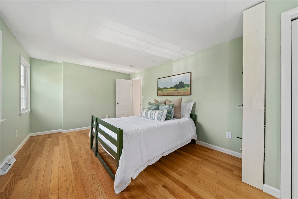 1563 Bay Road Sharon, MA 02067 - Photo 27 of 41 a bedroom with a bed and wooden floor
