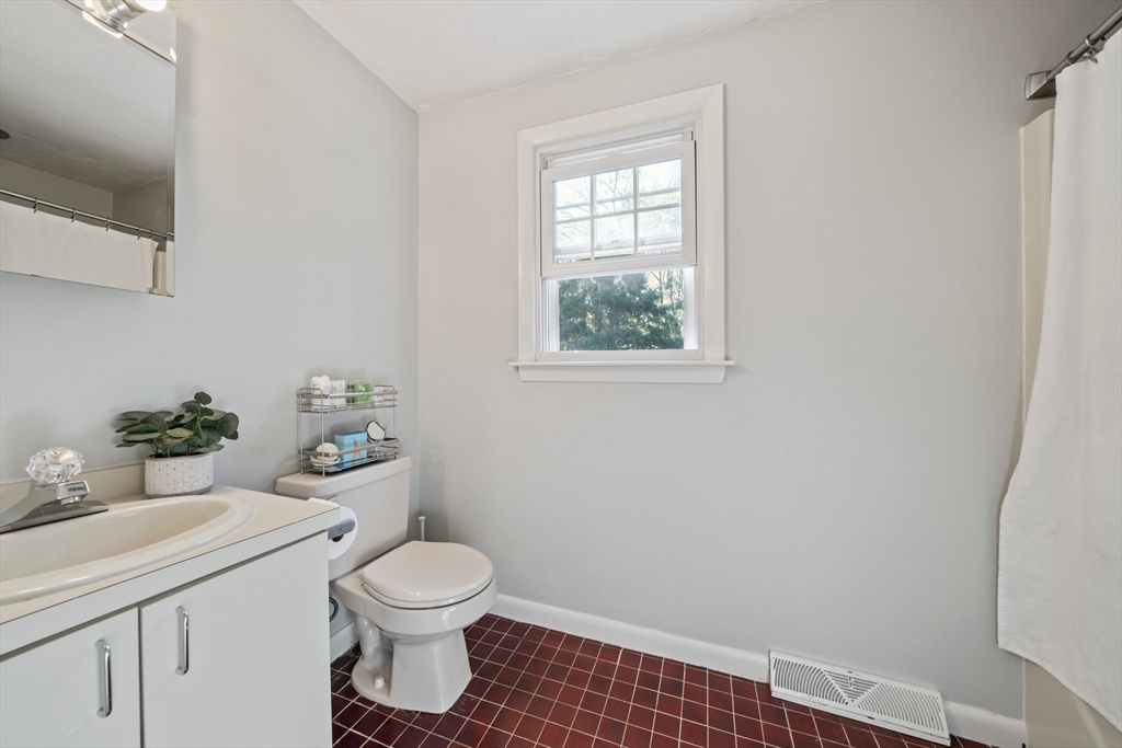 1563 Bay Road Sharon, MA 02067 - Photo 29 of 41 a bathroom with a sink a toilet and a window