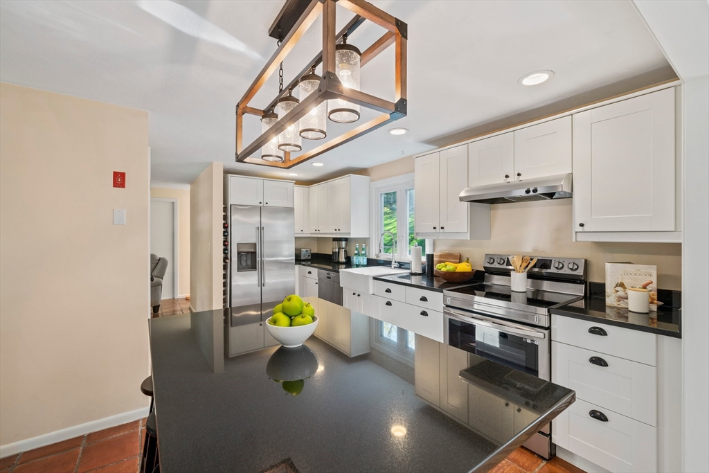 1563 Bay Road Sharon, MA 02067 - Photo 8 of 41 a kitchen with stainless steel appliances a stove a sink and white cabinets