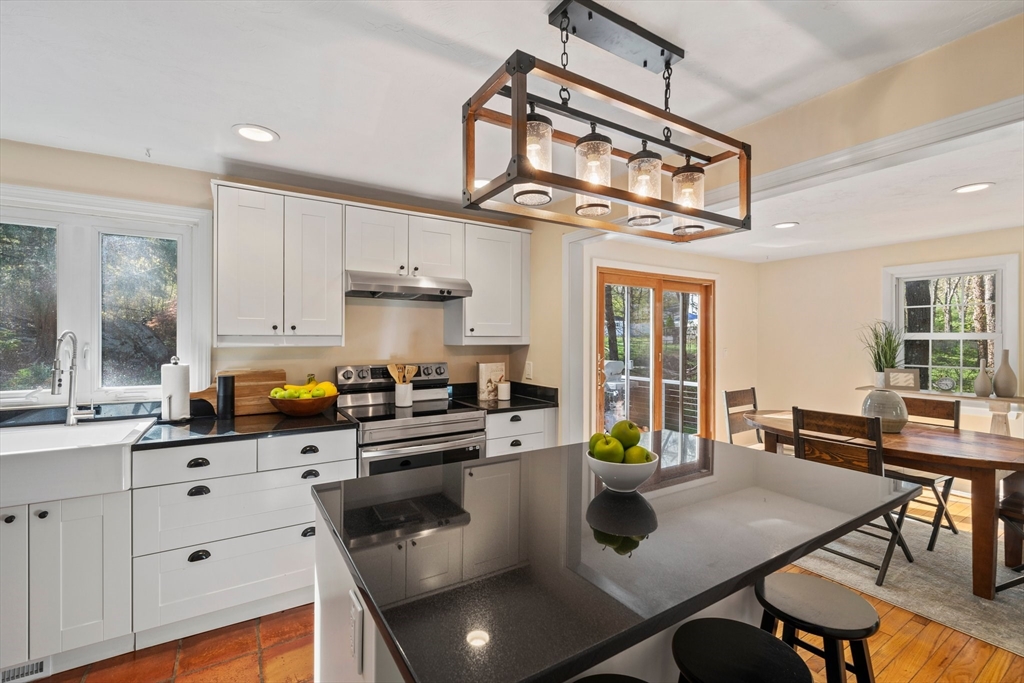 1563 Bay Road Sharon, MA 02067 - Photo 9 of 41 a kitchen with a table chairs and cabinets