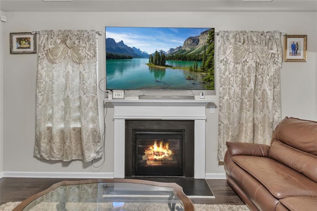 171 Pinnacle Point Court Dallas, GA 30132 - Photo 11 of 26 a living room with furniture and a fireplace