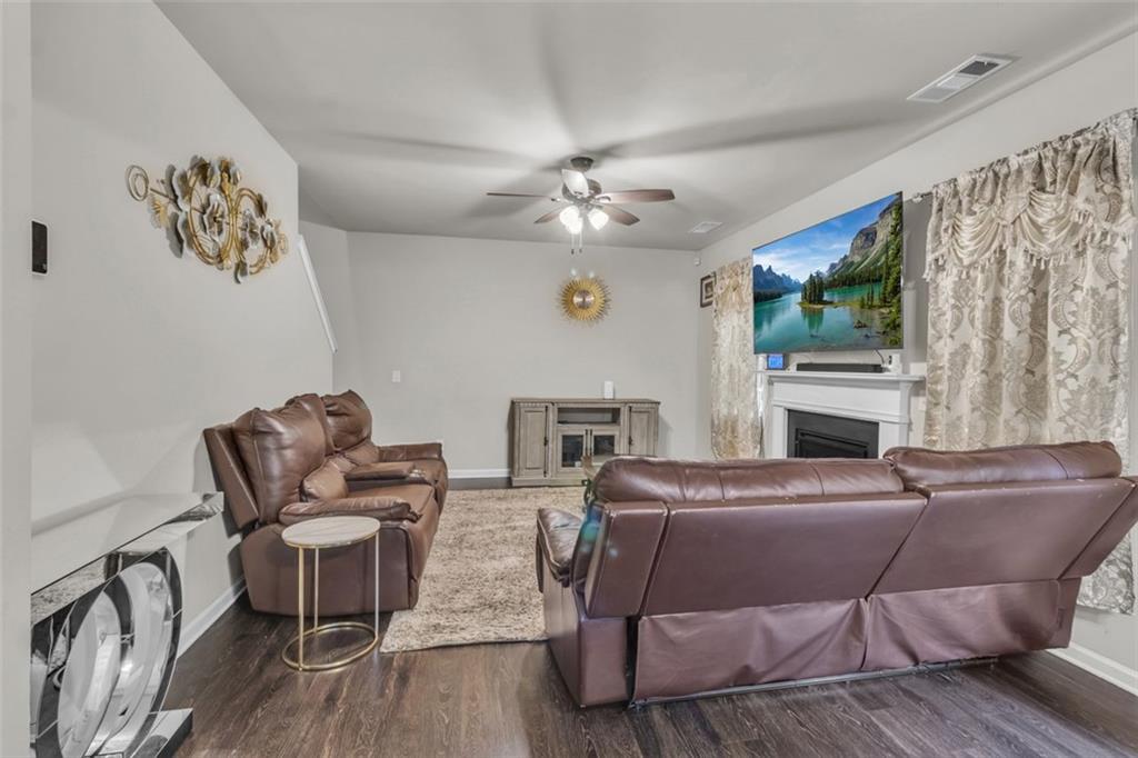 171 Pinnacle Point Court Dallas, GA 30132 - Photo 13 of 26 a living room with furniture a fireplace and a large window