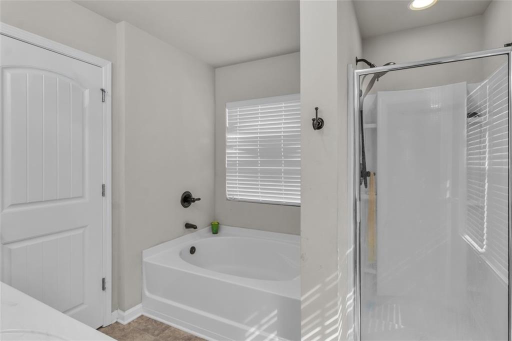 171 Pinnacle Point Court Dallas, GA 30132 - Photo 17 of 26 a bathroom with a tub shower and a sink