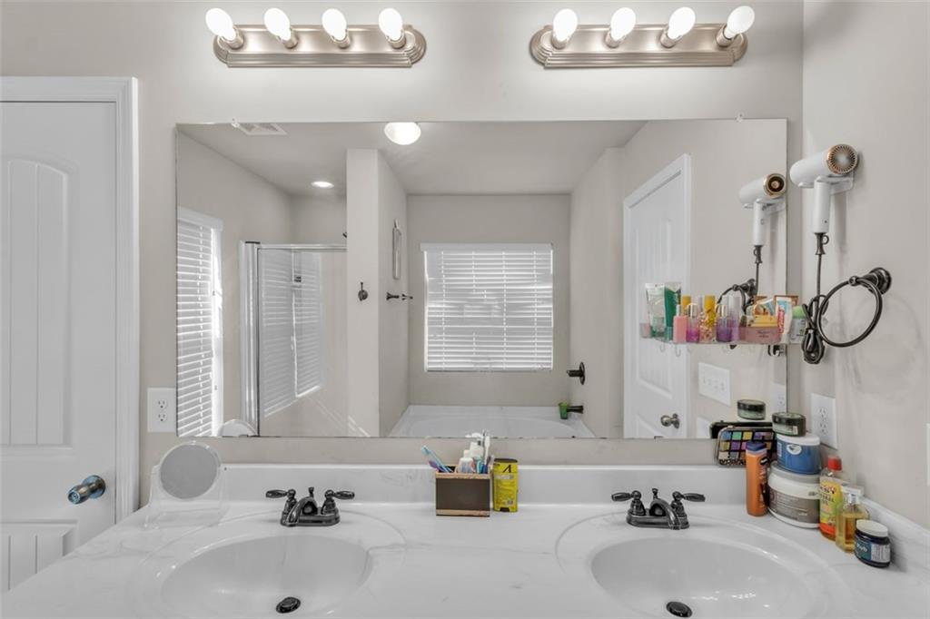 171 Pinnacle Point Court Dallas, GA 30132 - Photo 18 of 26 a bathroom with a tub sink and a large mirror