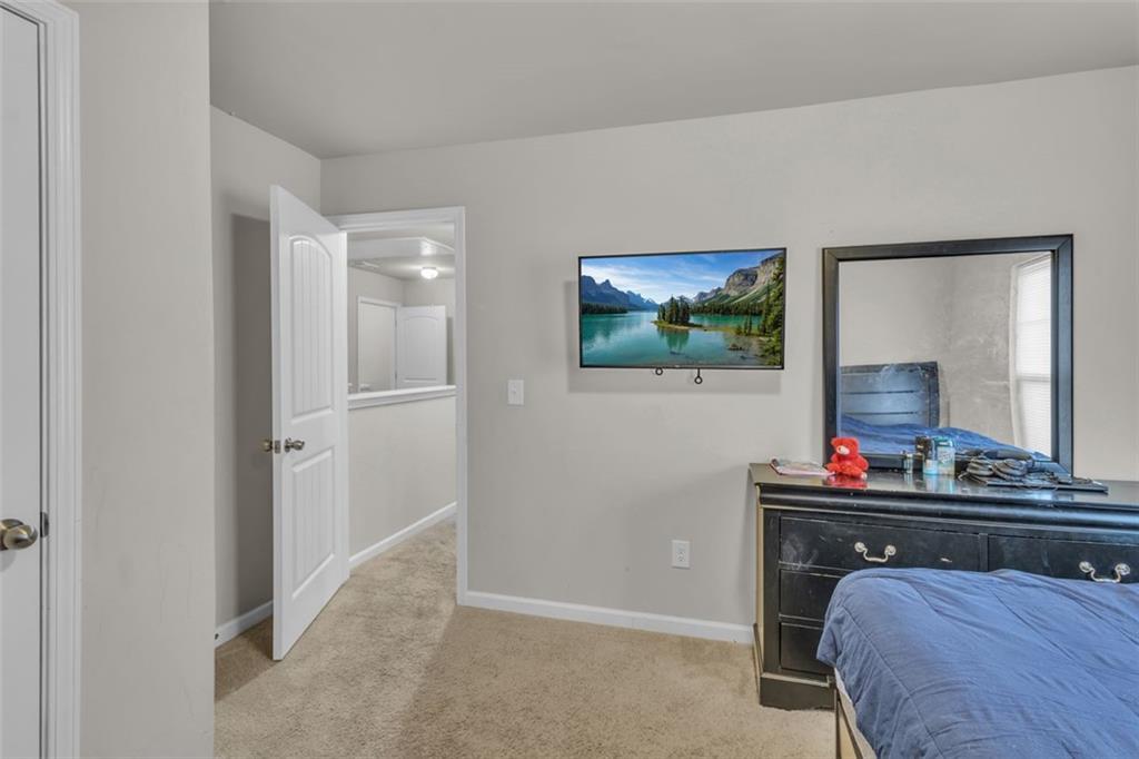 171 Pinnacle Point Court Dallas, GA 30132 - Photo 20 of 26 a living room with furniture and a flat screen tv