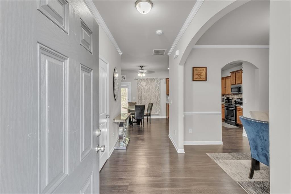 171 Pinnacle Point Court Dallas, GA 30132 - Photo 5 of 26 a view of a hallway with wooden floor and a living room