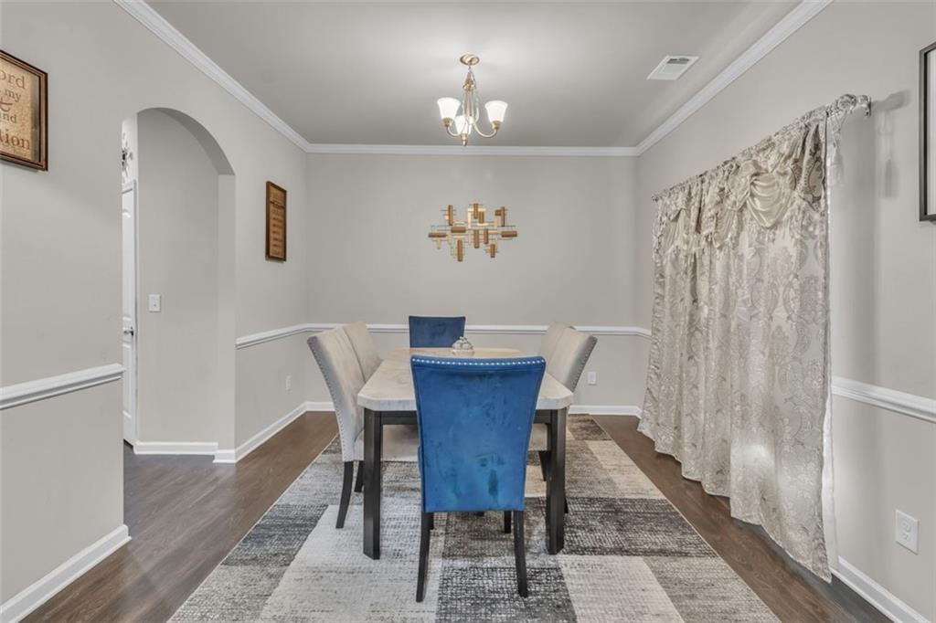 171 Pinnacle Point Court Dallas, GA 30132 - Photo 6 of 26 a view of a dining room with furniture wooden floor and a chandelier