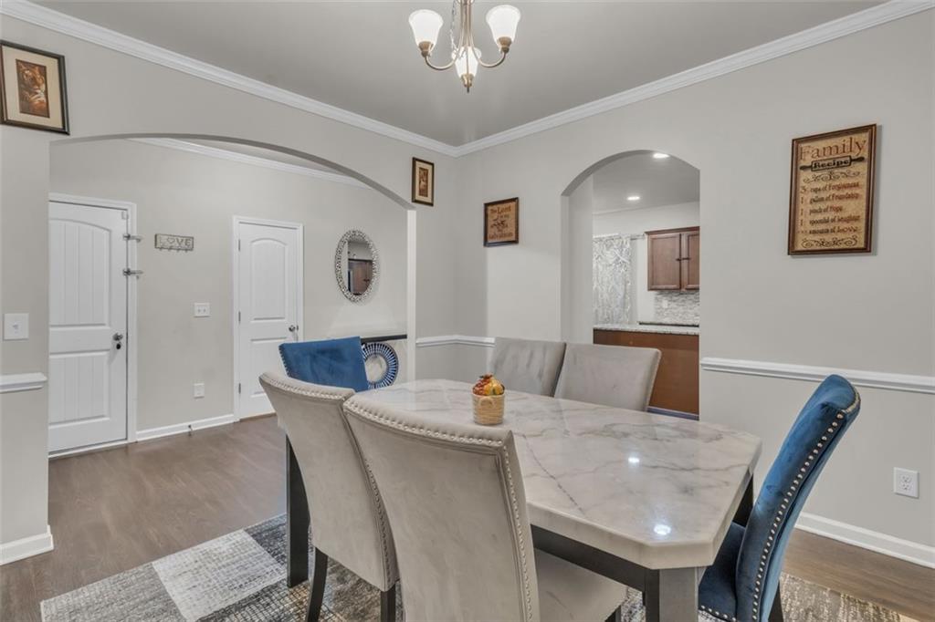 171 Pinnacle Point Court Dallas, GA 30132 - Photo 7 of 26 a view of a dining room with furniture and wooden floor