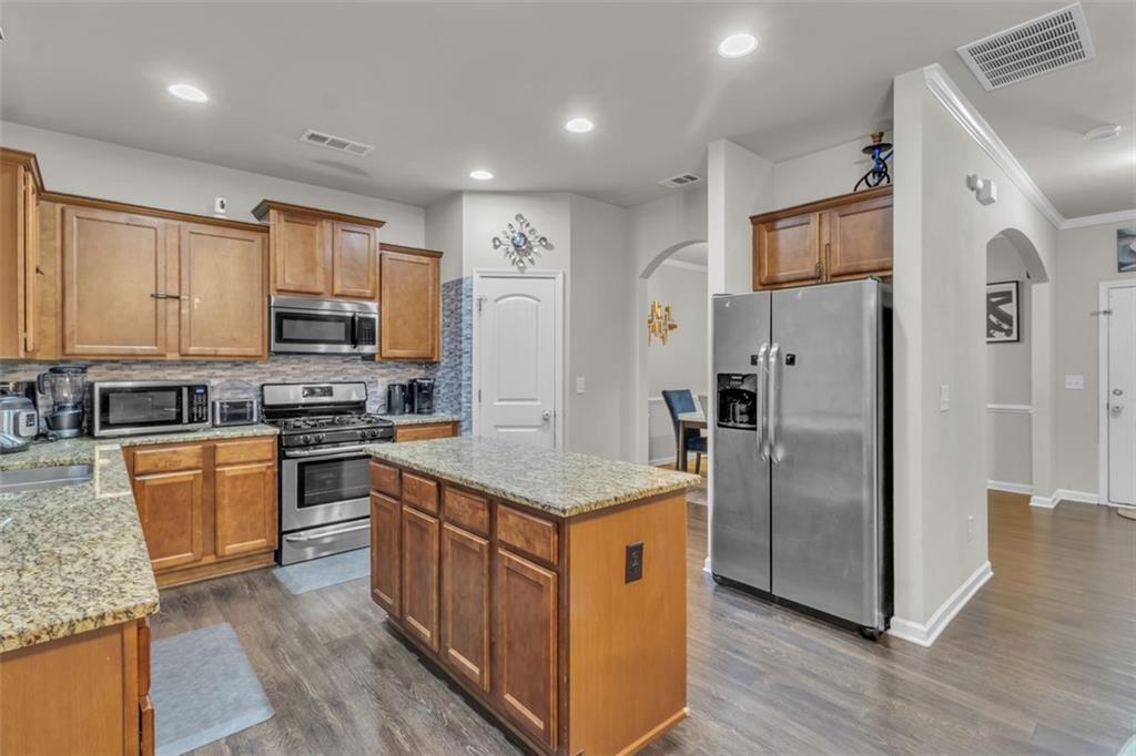 171 Pinnacle Point Court Dallas, GA 30132 - Photo 8 of 26 a kitchen with stainless steel appliances granite countertop a refrigerator a stove a sink and a microwave