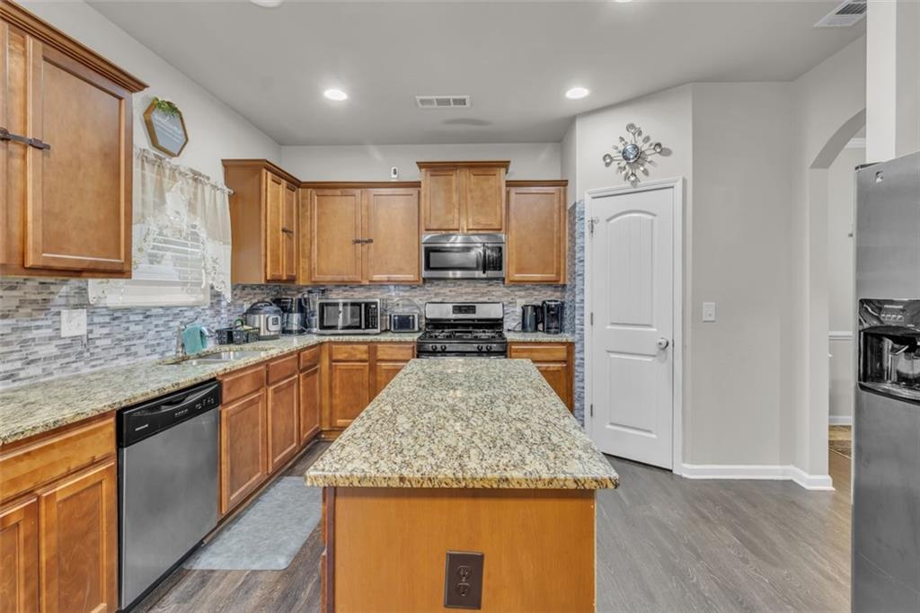 171 Pinnacle Point Court Dallas, GA 30132 - Photo 9 of 26 a kitchen with stainless steel appliances granite countertop a sink stove and refrigerator
