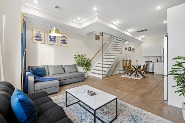 a living room with furniture and wooden floor