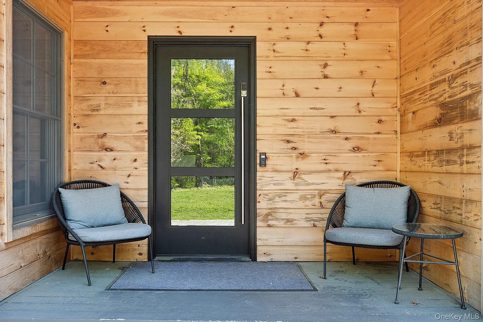 12 North Quarter Road Westhampton, NY 11977 - Photo 17 of 23 a outdoor sitting area with a couch and a window