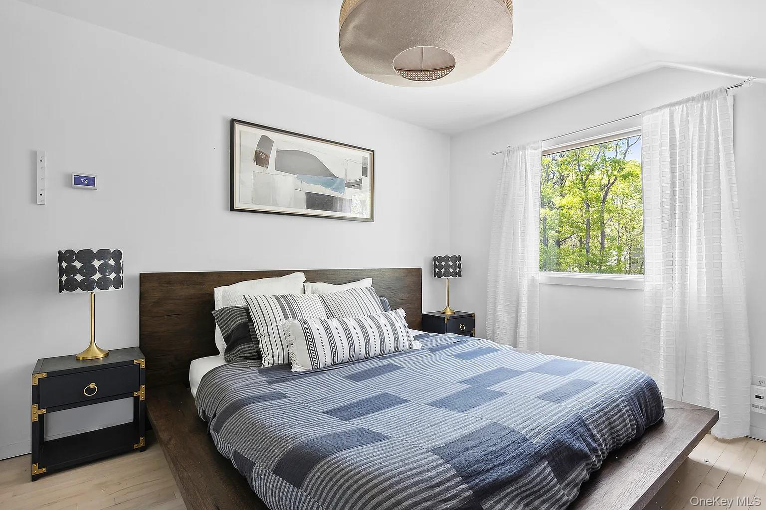 12 North Quarter Road Westhampton, NY 11977 - Photo 20 of 23 a bedroom with a bed and a window