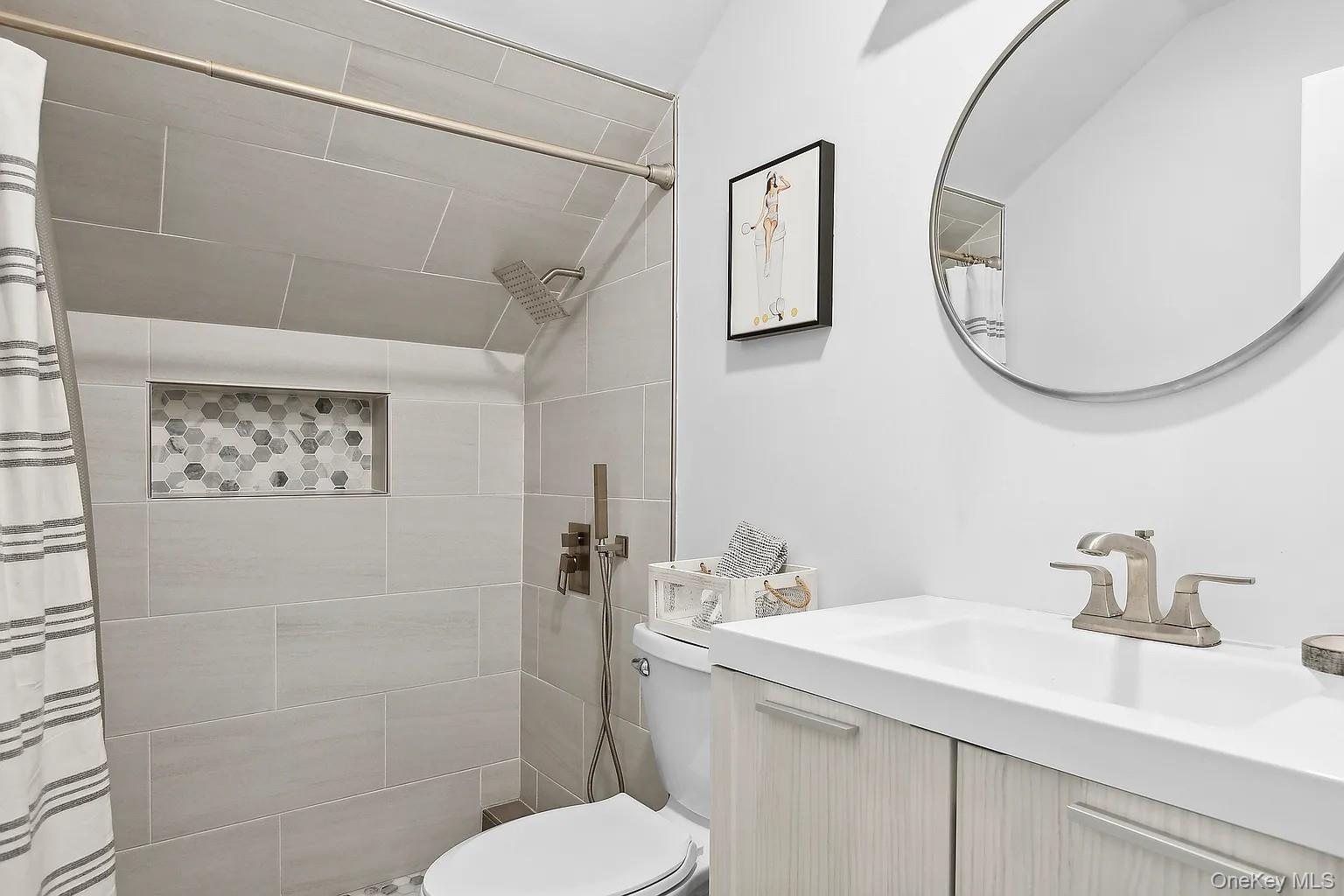 12 North Quarter Road Westhampton, NY 11977 - Photo 23 of 23 a bathroom with a sink a mirror and a toilet