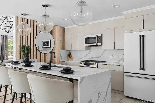 a kitchen with stainless steel appliances a sink stove and a refrigerator