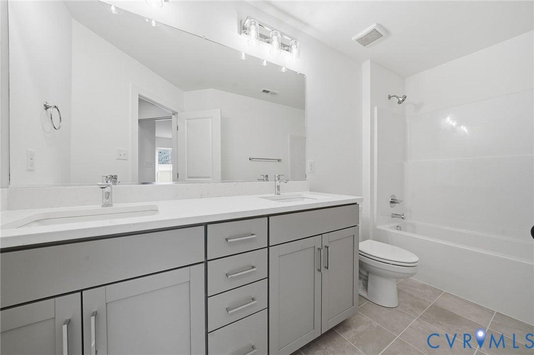 12006 Afternoon Path Henrico, VA 23233 - Photo 13 of 22 a bathroom with a double vanity sink toilet and a mirror