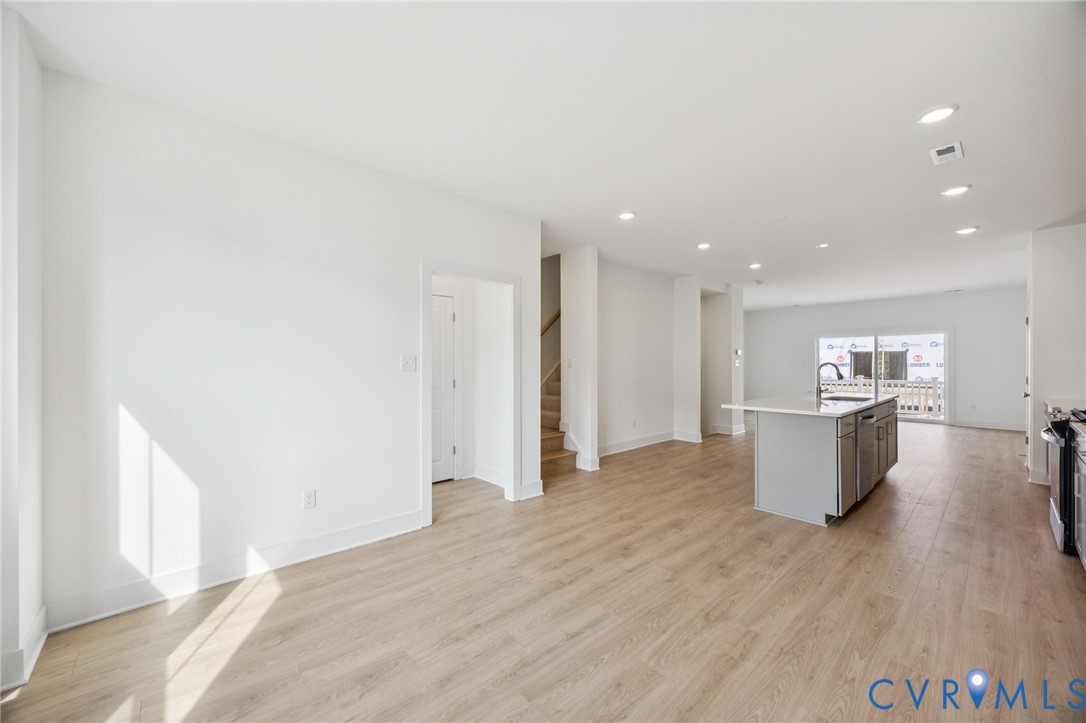12006 Afternoon Path Henrico, VA 23233 - Photo 4 of 22 a view of kitchen with stainless steel appliances kitchen island wooden floors and living room view