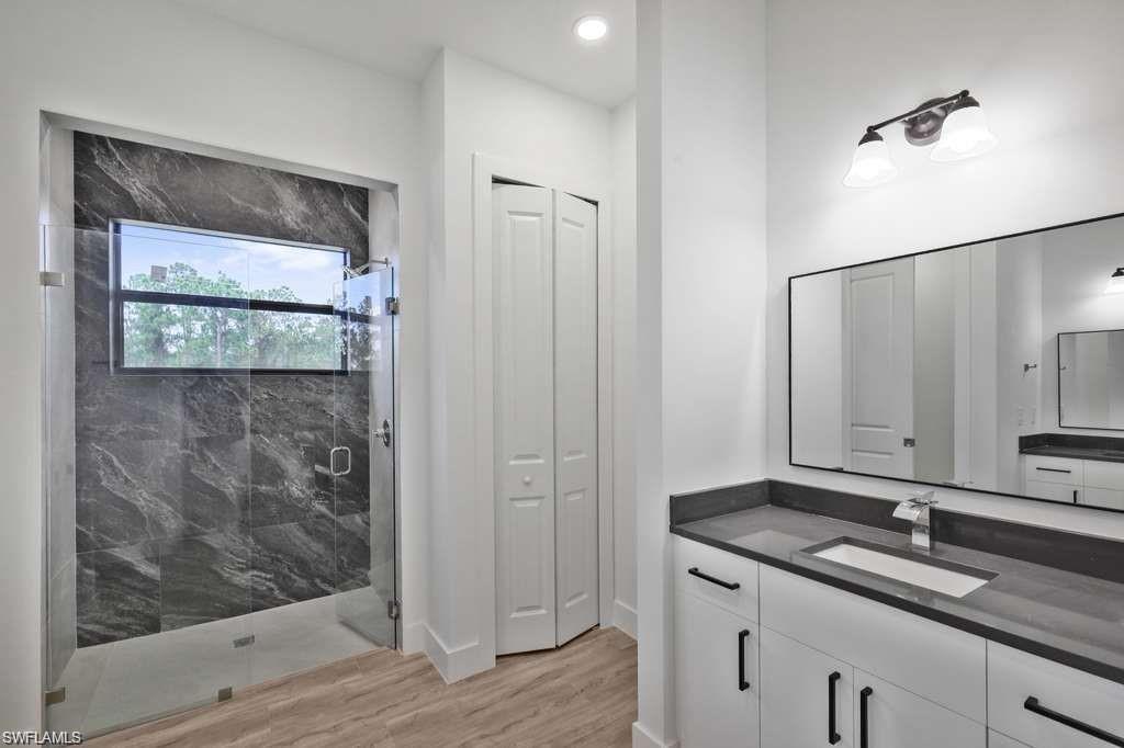 812 Homestead Road South Lehigh Acres, FL 33974 - Photo 11 of 21 a bathroom with a granite countertop sink mirror and shower