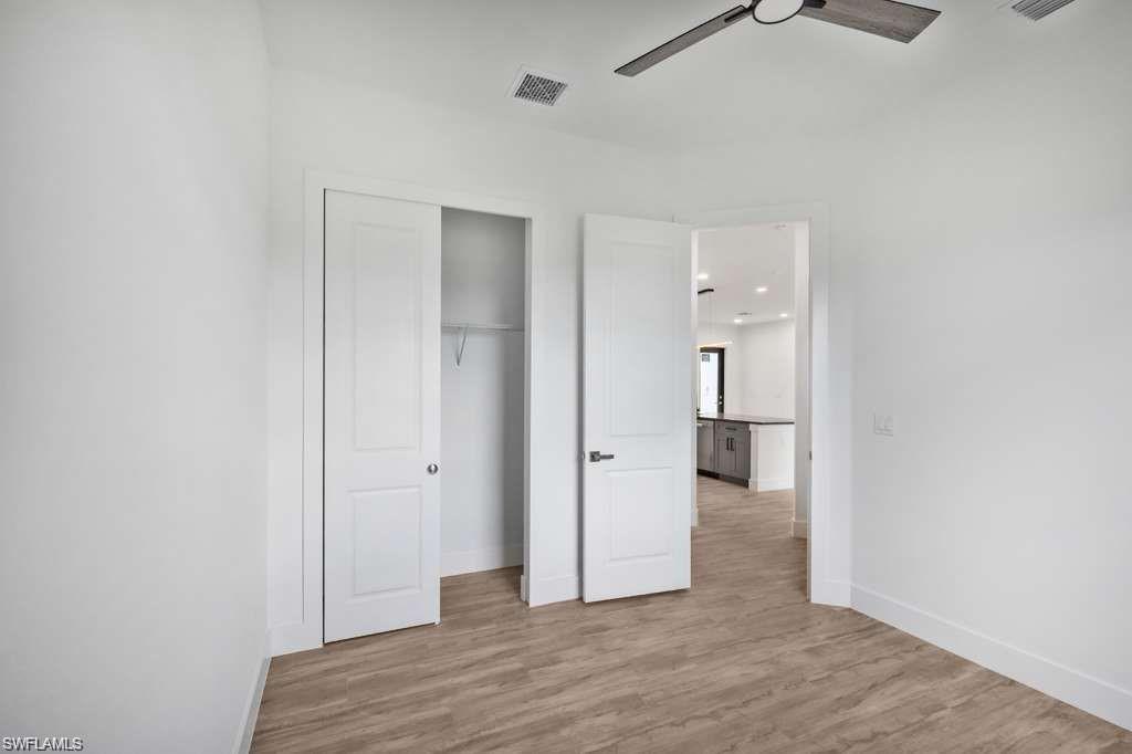 812 Homestead Road South Lehigh Acres, FL 33974 - Photo 14 of 21 a view of a hallway with wooden floor and closet