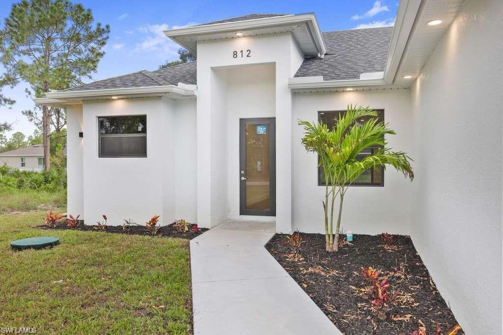 812 Homestead Road South Lehigh Acres, FL 33974 - Photo 18 of 21 a front view of a house with a yard