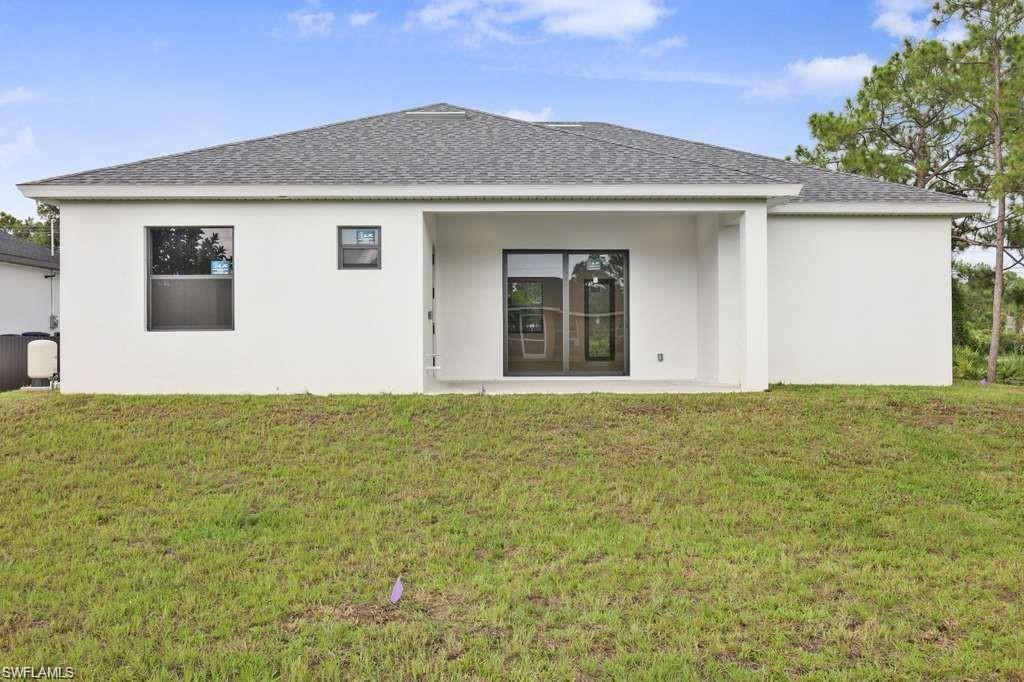 812 Homestead Road South Lehigh Acres, FL 33974 - Photo 19 of 21 two view of an house with backyard space