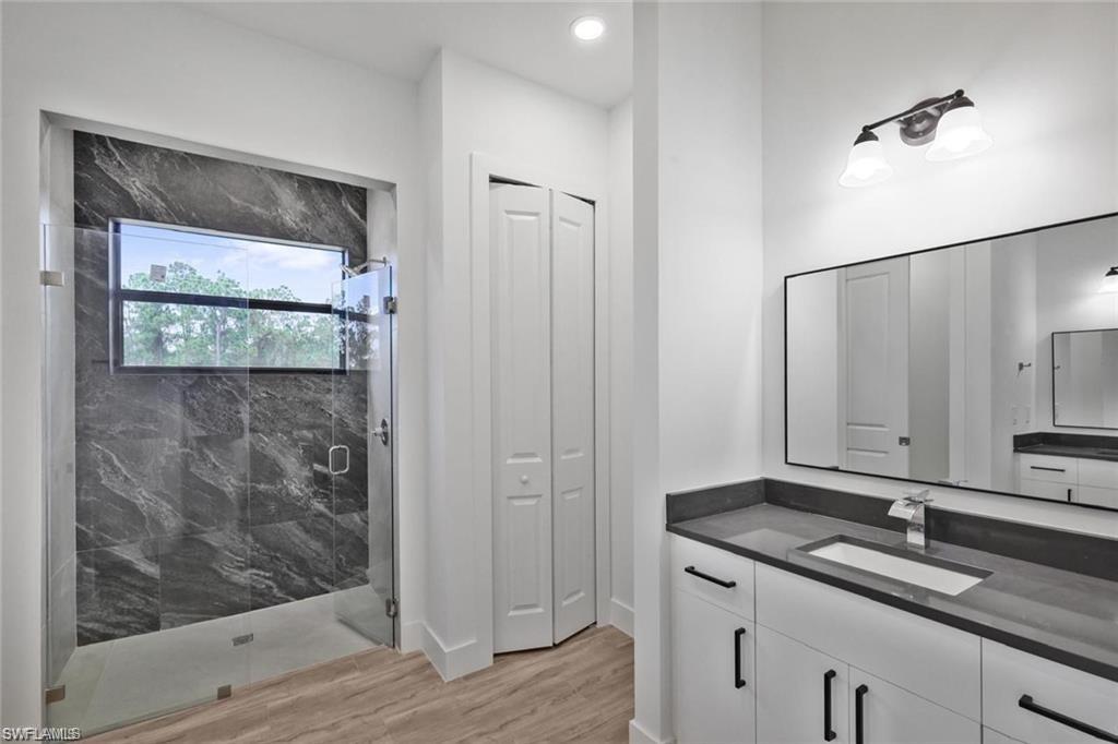 812 Homestead Road South Lehigh Acres, FL 33974 - Photo 6 of 21 a bathroom with a double vanity sink and mirror