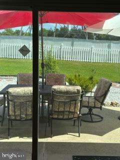 25 Country Club Road Willingboro, NJ 08046 - Photo 1 of 13 a view of a patio with table and chairs potted plants with wooden fence