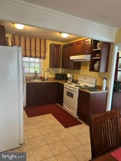 25 Country Club Road Willingboro, NJ 08046 - Photo 12 of 13 a kitchen with stainless steel appliances granite countertop a sink and wooden cabinets