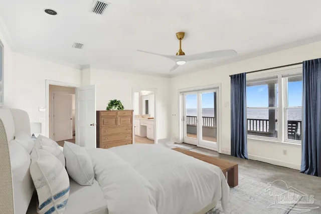 a bedroom with a large bed and wooden floor