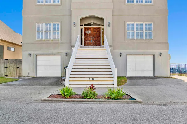 a front view of a house with a yard and a garage