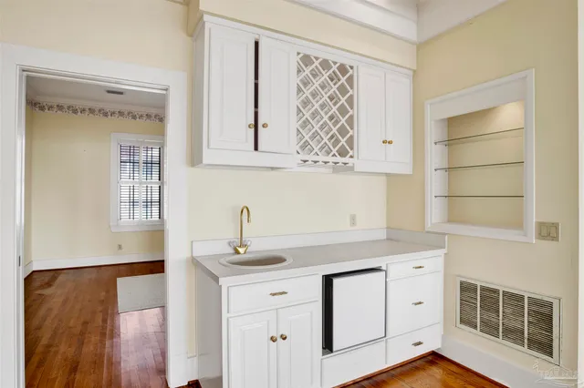 a view of staircase with railing and white walls