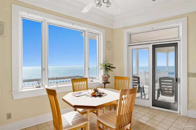 a view of an empty room with a window and kitchen view