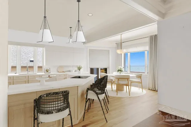 a kitchen with stainless steel appliances kitchen island granite countertop a refrigerator a stove a sink dishwasher and white cabinets with wooden floor