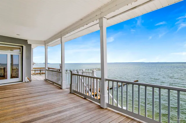 an aerial view of a house with a garden and lake view