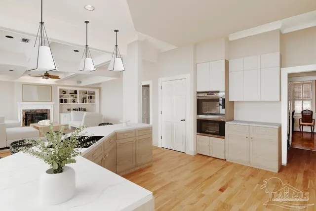 a kitchen with white cabinets and sink