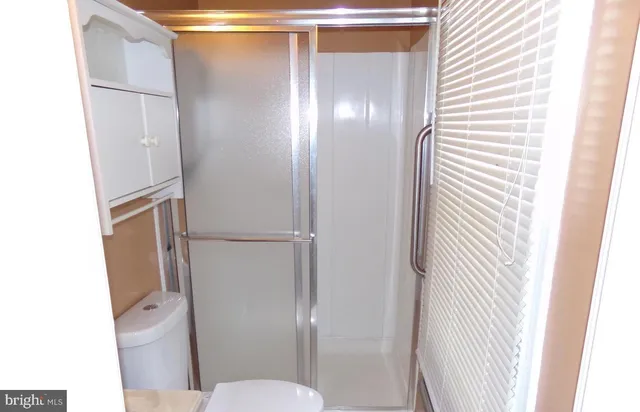 a bathroom with a glass shower door