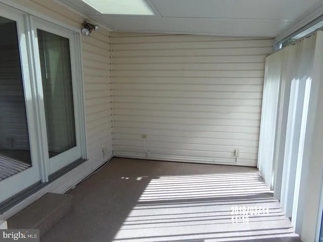 a view of a door and wooden floor